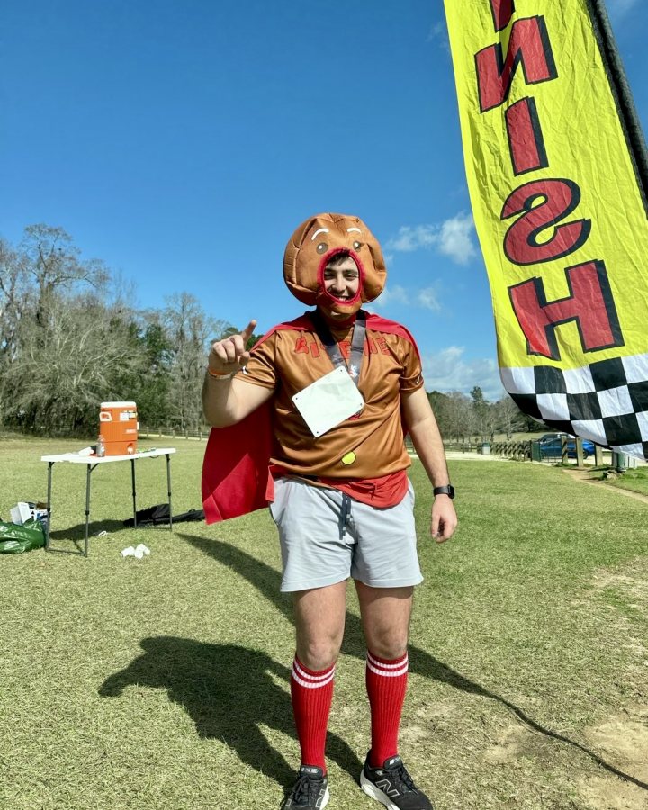 US Road Running race day photo with runners, walkers, finisher medals, and race staff