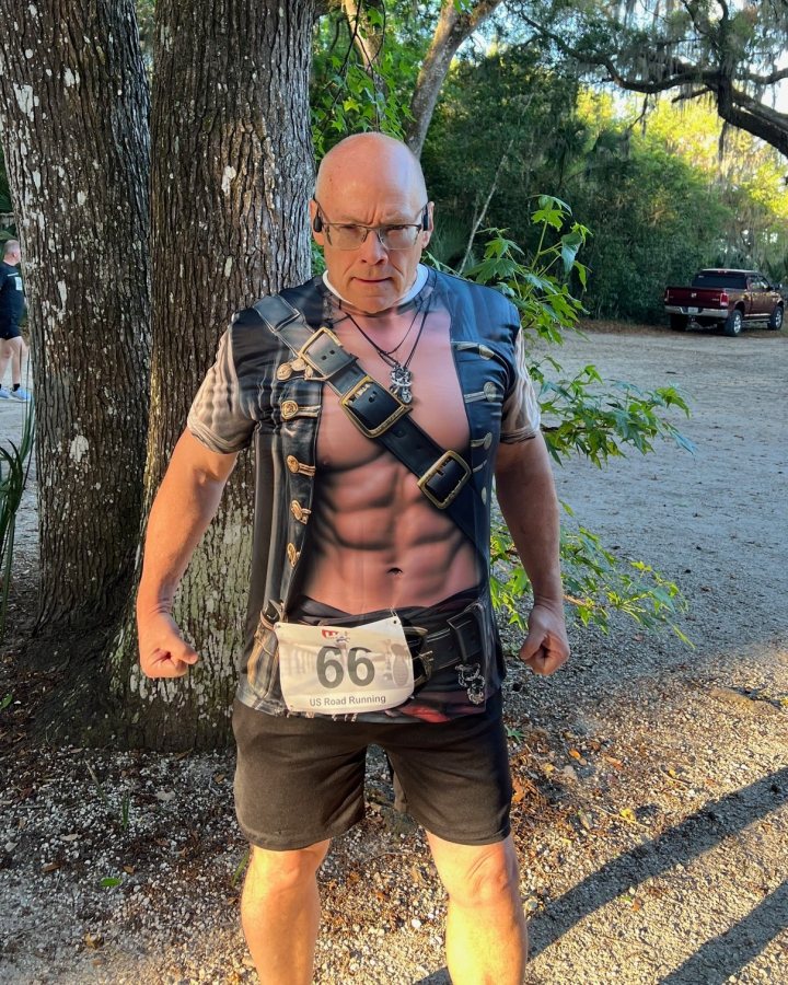 US Road Running race day photo with runners, walkers, finisher medals, and race staff