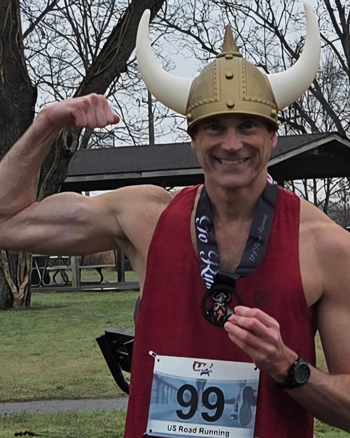 US Road Running race day photo with runners, walkers, finisher medals, and race staff