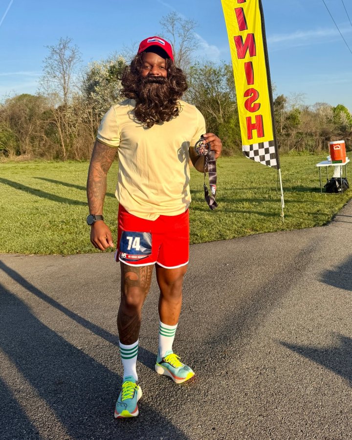 US Road Running race day photo with runners, walkers, finisher medals, and race staff
