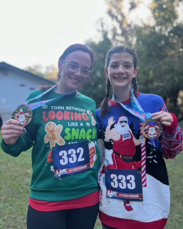 US Road Running race day photo with runners, walkers, finisher medals, and race staff