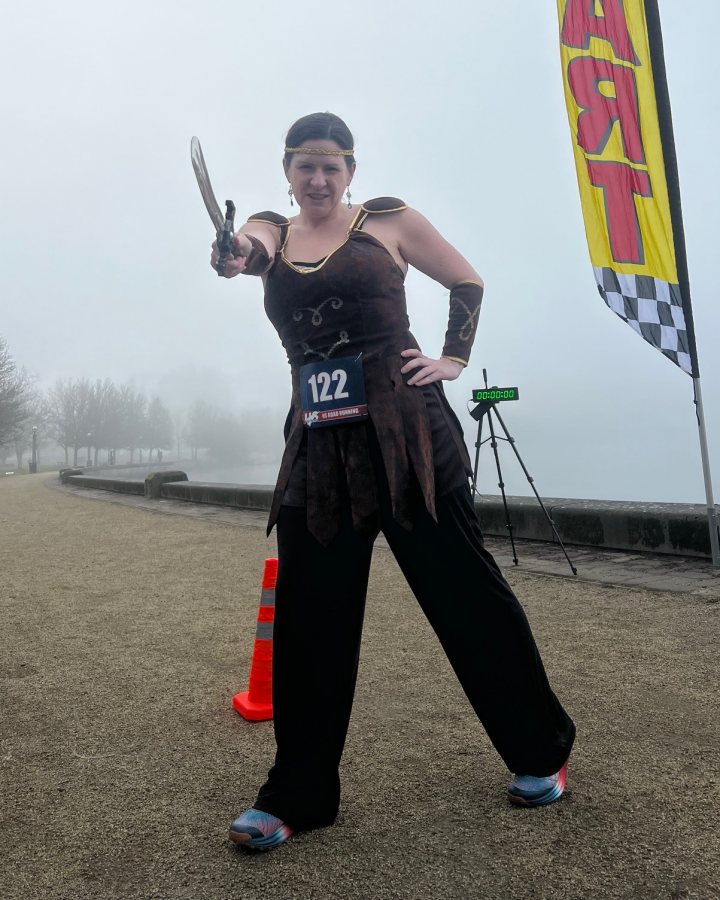 US Road Running race day photo with runners, walkers, finisher medals, and race staff