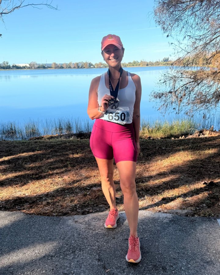 US Road Running race day photo with runners, walkers, finisher medals, and race staff