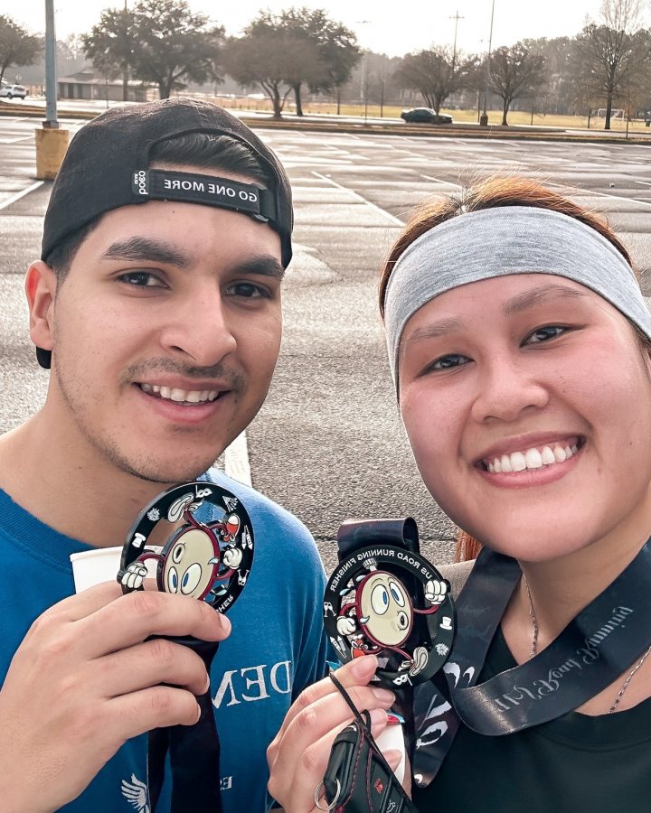 US Road Running race day photo with runners, walkers, finisher medals, and race staff