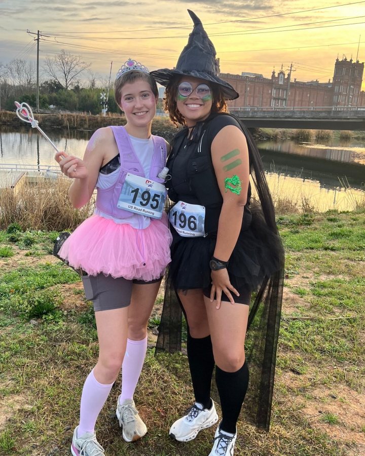 US Road Running race day photo with runners, walkers, finisher medals, and race staff