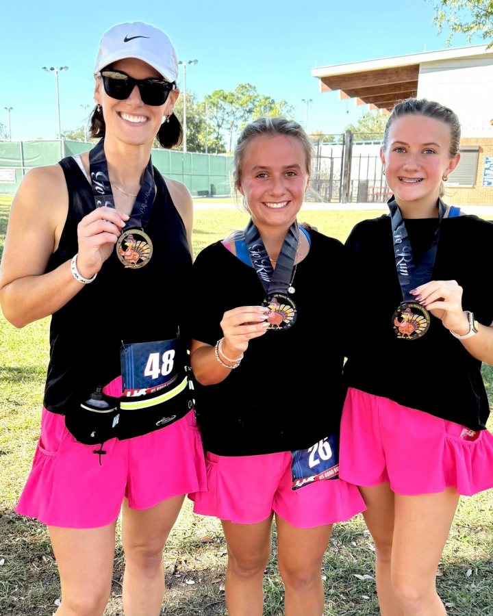 US Road Running race day photo with runners, walkers, finisher medals, and race staff