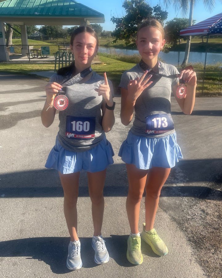 US Road Running race day photo with runners, walkers, finisher medals, and race staff