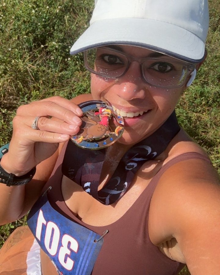 US Road Running race day photo with runners, walkers, finisher medals, and race staff