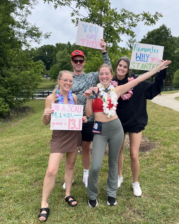 US Road Running race day photo with runners, walkers, finisher medals, and race staff